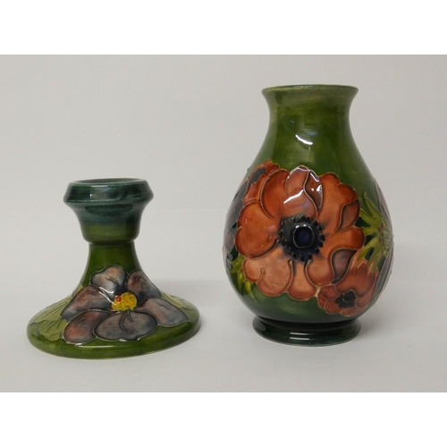 488 - Moorcroft - a circular candlestick and a vase decorated with Anemones on a green ground. Vase 14 cms... 