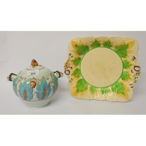 493 - A Clarice Cliff biscuit barrel and a relief moulded plate