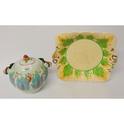 493 - A Clarice Cliff biscuit barrel and a relief moulded plate