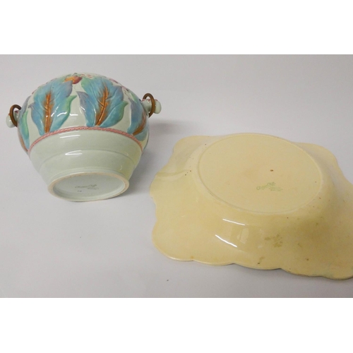 493 - A Clarice Cliff biscuit barrel and a relief moulded plate