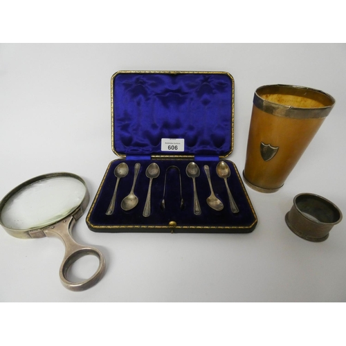 606 - A cased set of 6 teaspoons and sugar nips, a silver napkin ring, a large silver handled magnifying g... 