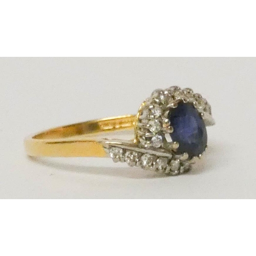 685 - A sapphire and diamond ring, the oval sapphire surrounded by diamonds in a cross over design setting... 