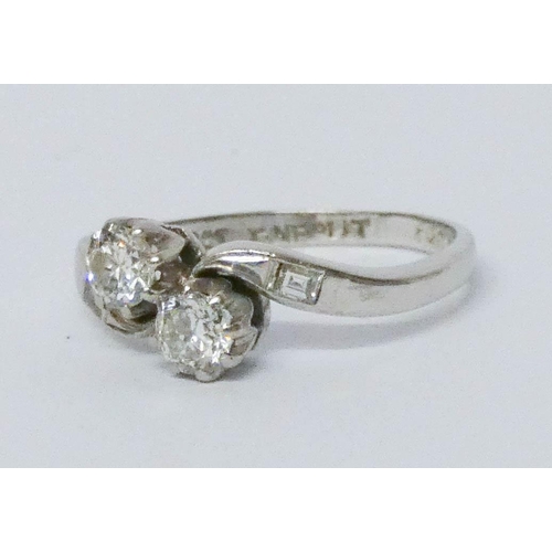 692 - A two stone diamond cross over design ring, on 18ct white gold and platinum setting, ring size J