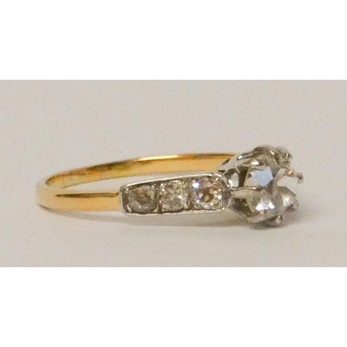 693 - A diamond ring, with a claw set diamond of approximately 3/4 of a carat on diamond shoulders, on 18c... 