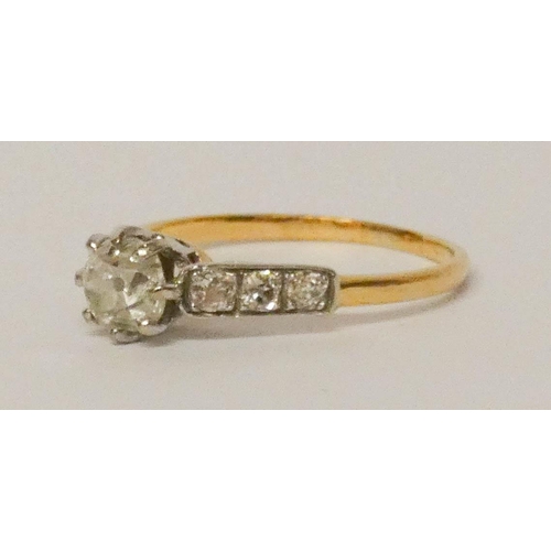 693 - A diamond ring, with a claw set diamond of approximately 3/4 of a carat on diamond shoulders, on 18c... 