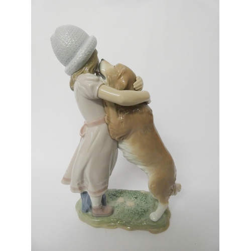 556 - A Lladro figurine of a girl with a dog 'A Warm Welcome' with original box