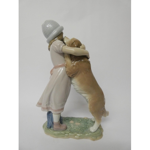 557 - A Lladro figurine of a girl with a dog 'A Warm Welcome' with original box