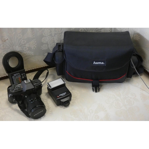 372 - A Pentax camera with accessories in fitted bag