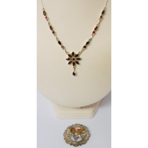 570 - A modern silver and garnet pendant necklace and a Scottish silver thistle motif brooch