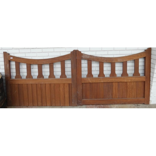 822 - A large pair of heavy teak wooden gates, overall width approximately 9' wide, 42