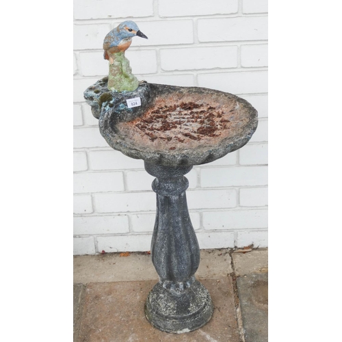 824 - A shell shaped reconstituted stone garden bird bath with decorative bird sitting on the edge...