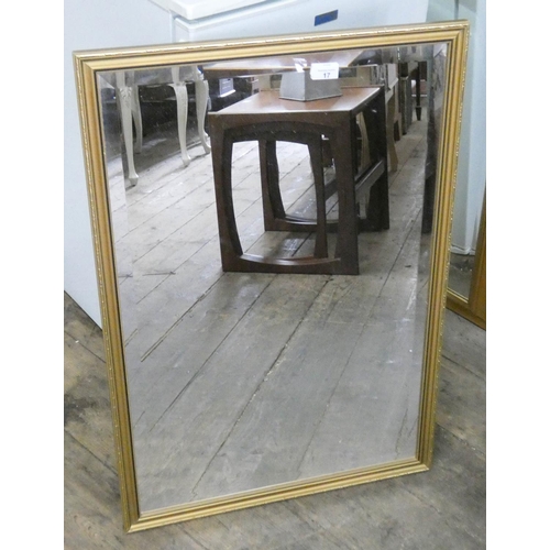 17 - A bevelled wall mirror in gilt frame