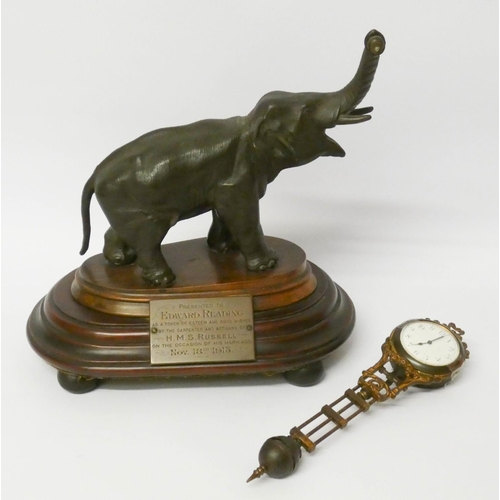 448 - An elephant mystery clock with presentation plaque, 