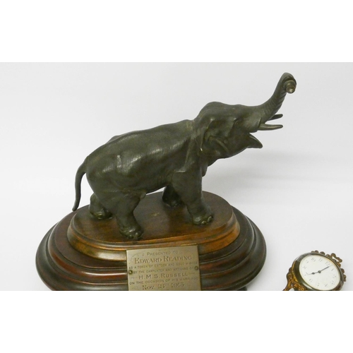 448 - An elephant mystery clock with presentation plaque, 