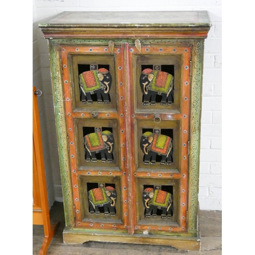 220 - An Indian style painted two door cabinet decorated with elephant panels, 2'6 wide