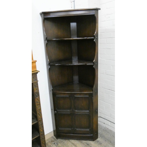 29 - An Ercol oak open corner cabinet with cupboard under...