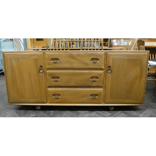 3 - An Ercol light elm low sideboard fitted three centre drawers and cupboards, 61