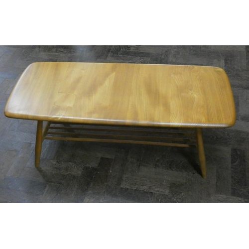 4 - An Ercol light elm long coffee table with under tier...