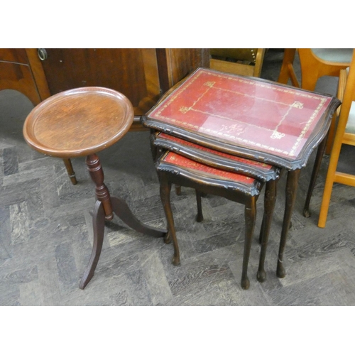 63 - A nest of three reproduction mahogany coffee tables with red leather and glass tops and a mahogany f... 