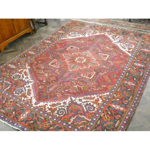 136 - A large red and patterned wool pile Persian rug, 9'8 x 6'10