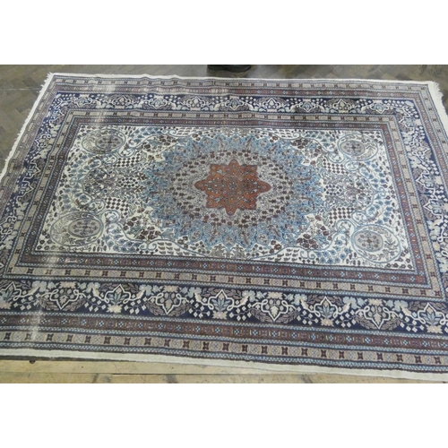 216 - A large cream and blue figured Persian design carpet measuring 9' x 6'