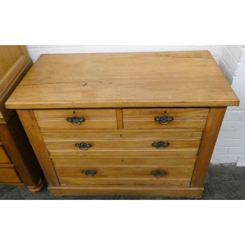 222 - An Edwardian stripped satin walnut chest of two short and two long drawers with brass handles