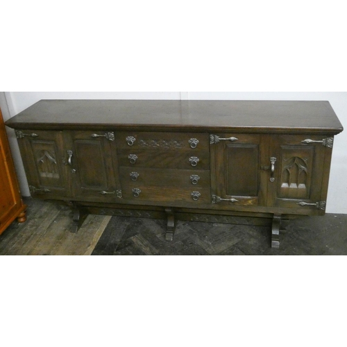 266 - A dark oak sideboard with Gothic arch tracery to the doors