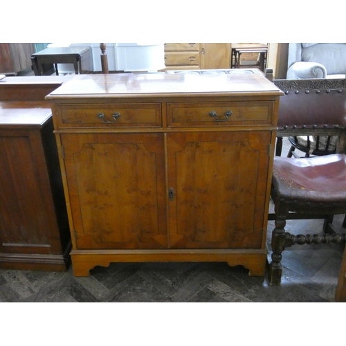 128 - A reproduction yew wood small sideboard fitted two drawers and cupboards, 3' wide