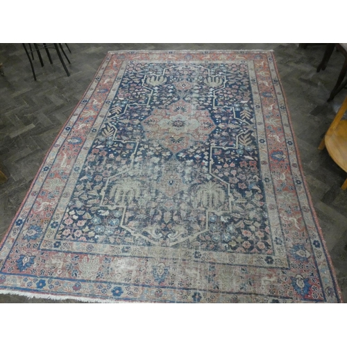 135 - A large figured Persian rug (worn), 9'9 x 5'6