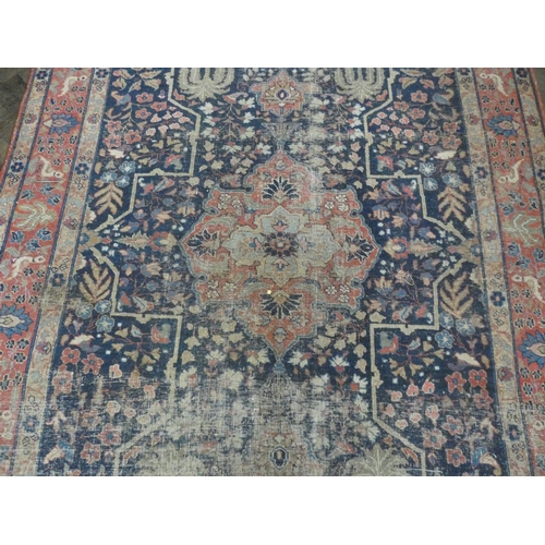 135 - A large figured Persian rug (worn), 9'9 x 5'6