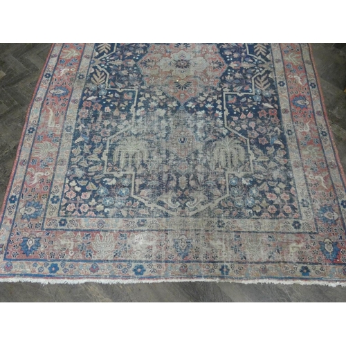 135 - A large figured Persian rug (worn), 9'9 x 5'6