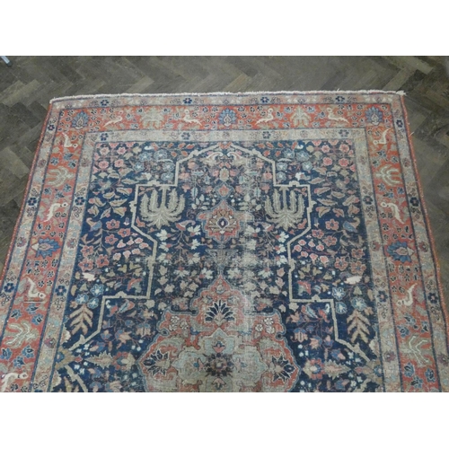 135 - A large figured Persian rug (worn), 9'9 x 5'6