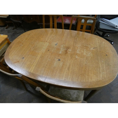 96 - A Nathan teak oval extending dining table and four similar high slat back chairs with upholstered se... 