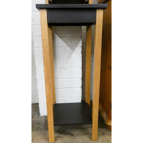 240 - A small oak CD rack and a dark brown leather and oak two tier plant pedestal