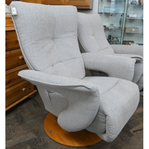 254 - A pair of modern Himolla swivel reclining easy chairs in a pale grey chenille