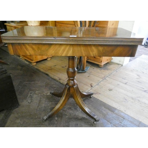 58 - A Georgian style mahogany fold over top card table on pillar and quadruple base, 3' wide...