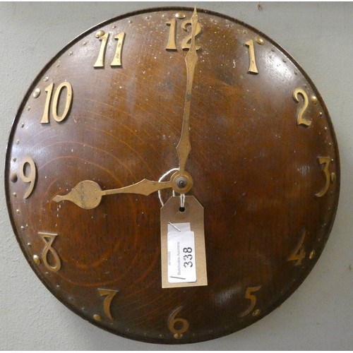 338 - An Arts & Crafts  oak convex wall clock with brass applied numerals. Impressed number 8103 to revers... 