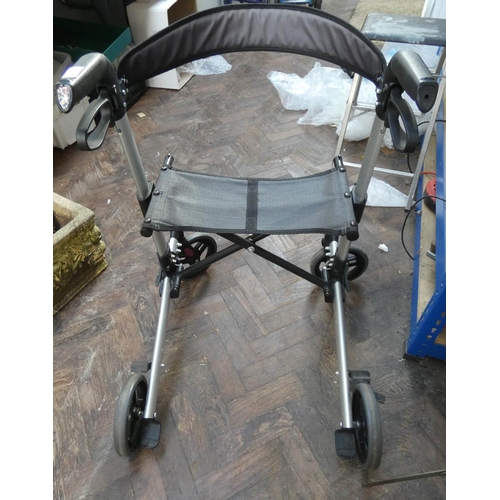 318 - A four wheel foldup Zimmer frame with seat and brakes etc