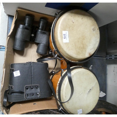 375 - Two pairs of binoculars and a pair of TomTom drums