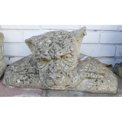 490 - A large reconstituted stone weathered gargoyle with crossed arms