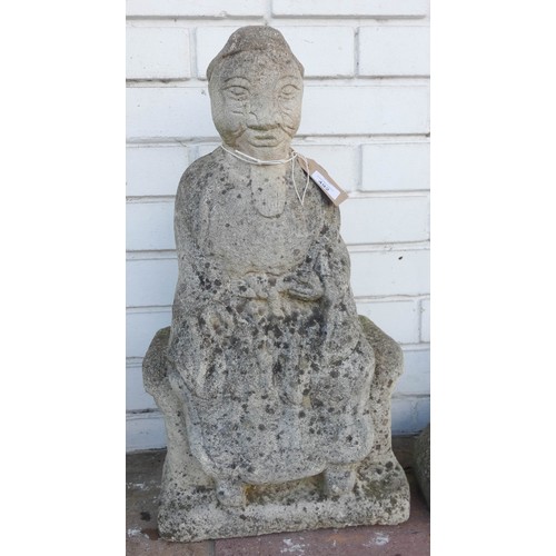 492 - A weathered reconstituted stone garden ornament of a seated Buddha