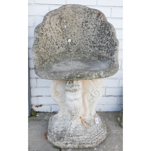 495 - A weathered reconstituted stone shell shaped garden seat