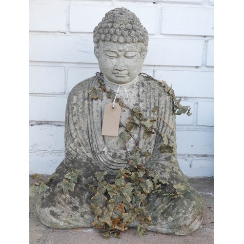 496 - A weathered reconstituted stone oriental garden Buddha