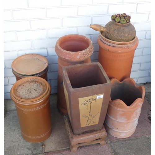 499 - Six terracotta chimney pots, garden planters and a kettle style planter