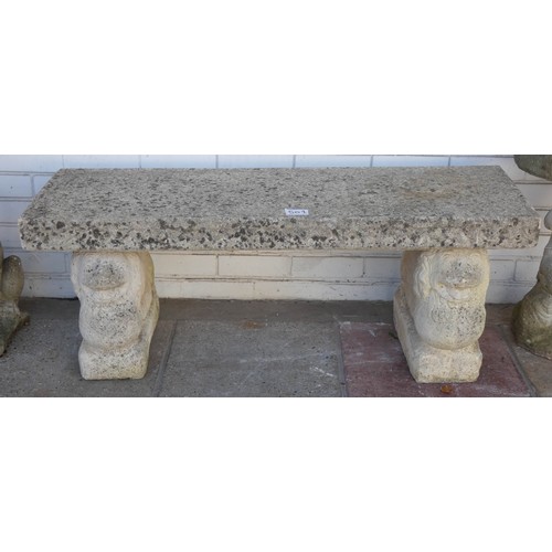 501 - A reconstituted stone rectangular shaped top two seater garden bench seat standing on headed bases