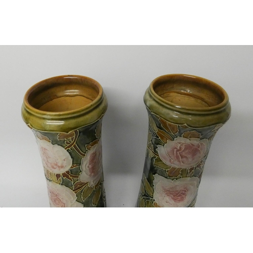 532 - A pair of Royal Doulton stoneware vases decorated with pink roses on a green marbled ground, height ... 