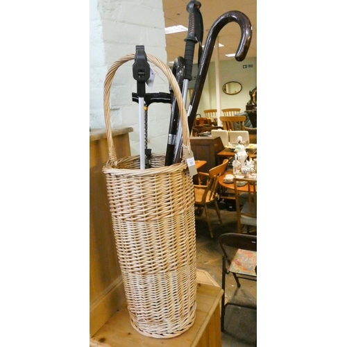 191 - A wicker work stick stand, four various walking sticks and a littler picker
