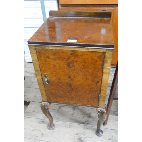 39 - A figured walnut bedside cabinet on cabriole legs