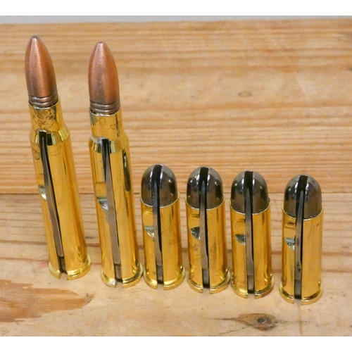 219 - A collection of brass bullet shaped penknives