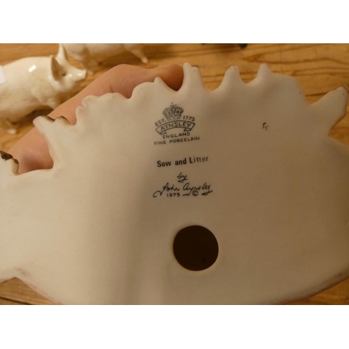 222 - Two Beswick models of pigs, a small Doulton pig and two Aynsley pigs